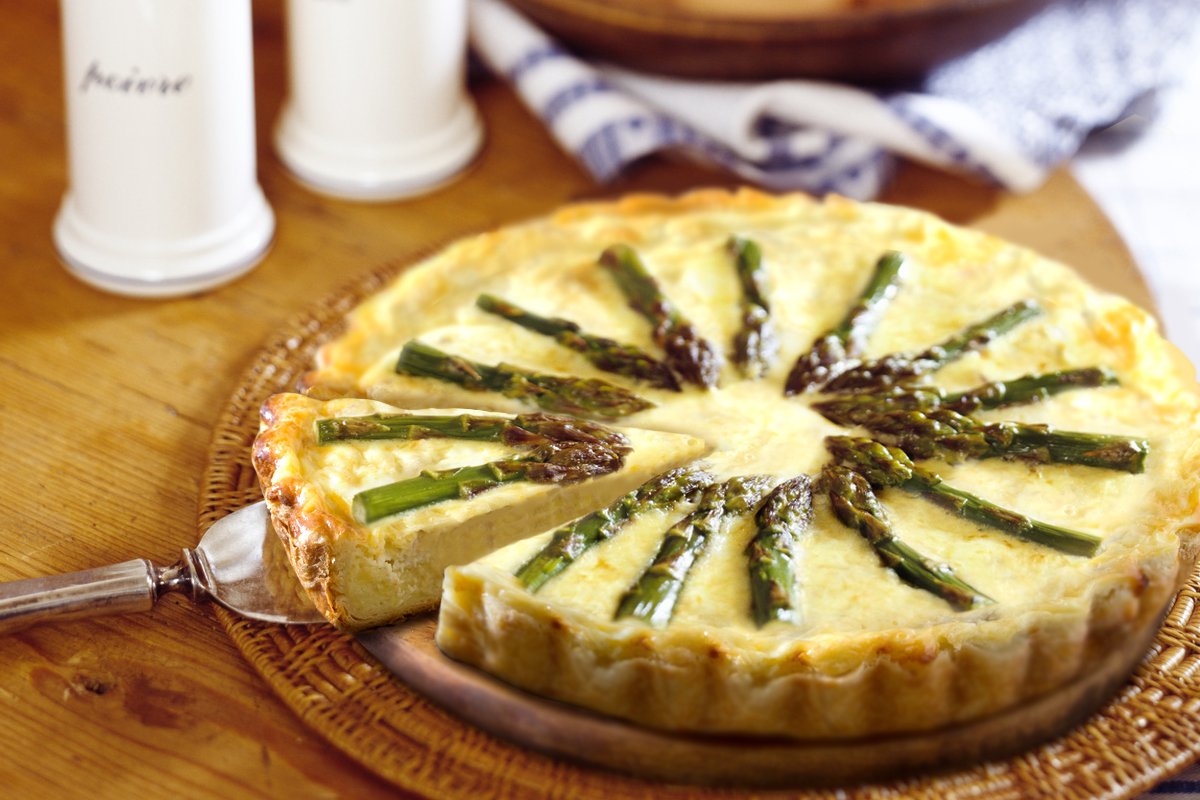 Serving quiche on table, close-up